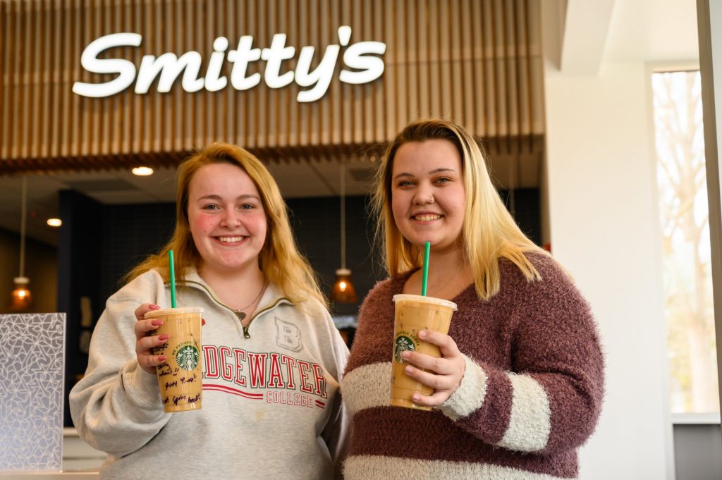 Two females enjoying Starbucks inside Smitty's Cafe in the Forrer Learning Commons
