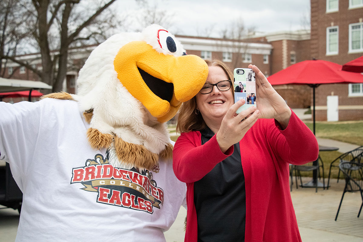 Women taking a selfie with B-C Eagle mascot, Ernie