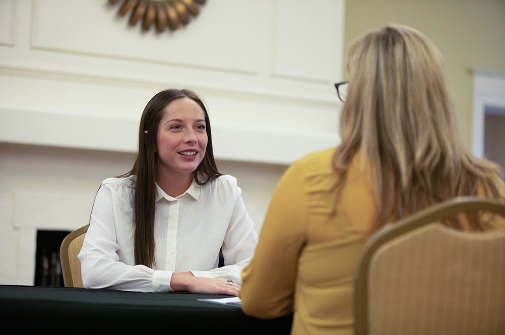 Women speaking to another women during mock interviews