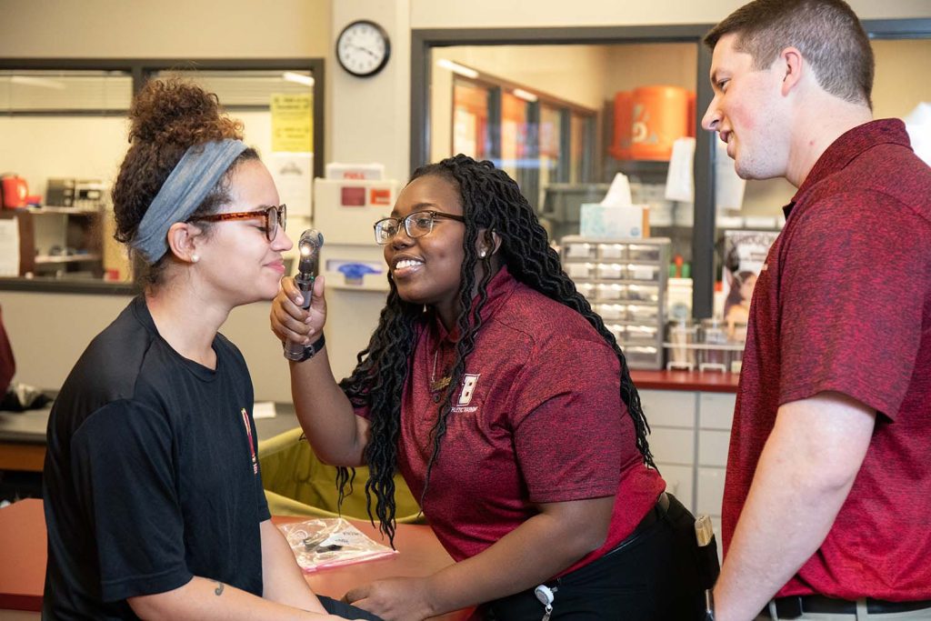 Student examining another student for an athletic training class