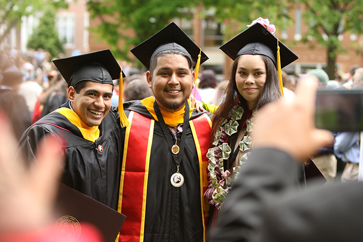 Three Bridgewater graduates posing for a photo together