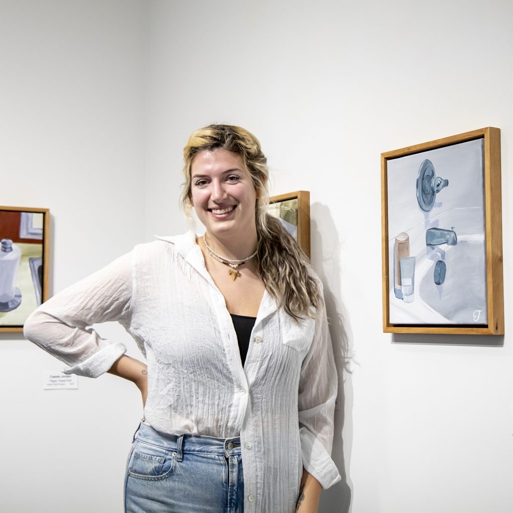 Student standing in front of her senior art project