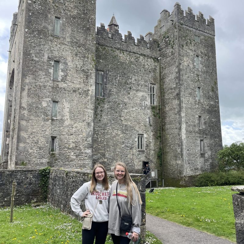 Two students standing in front of castle on study abroad trip