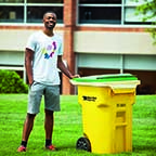 Devin Lattimore  next to trash can for sustainability project