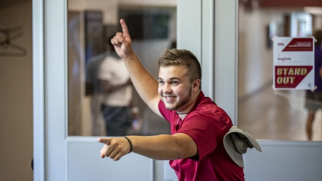 Student ambassador smiling and pointing