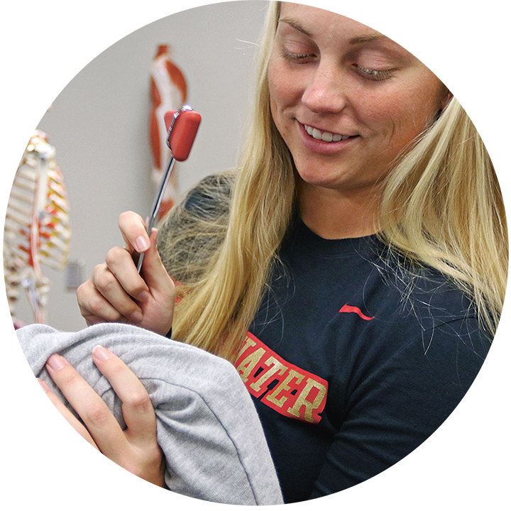 Female student practicing Athletic Training