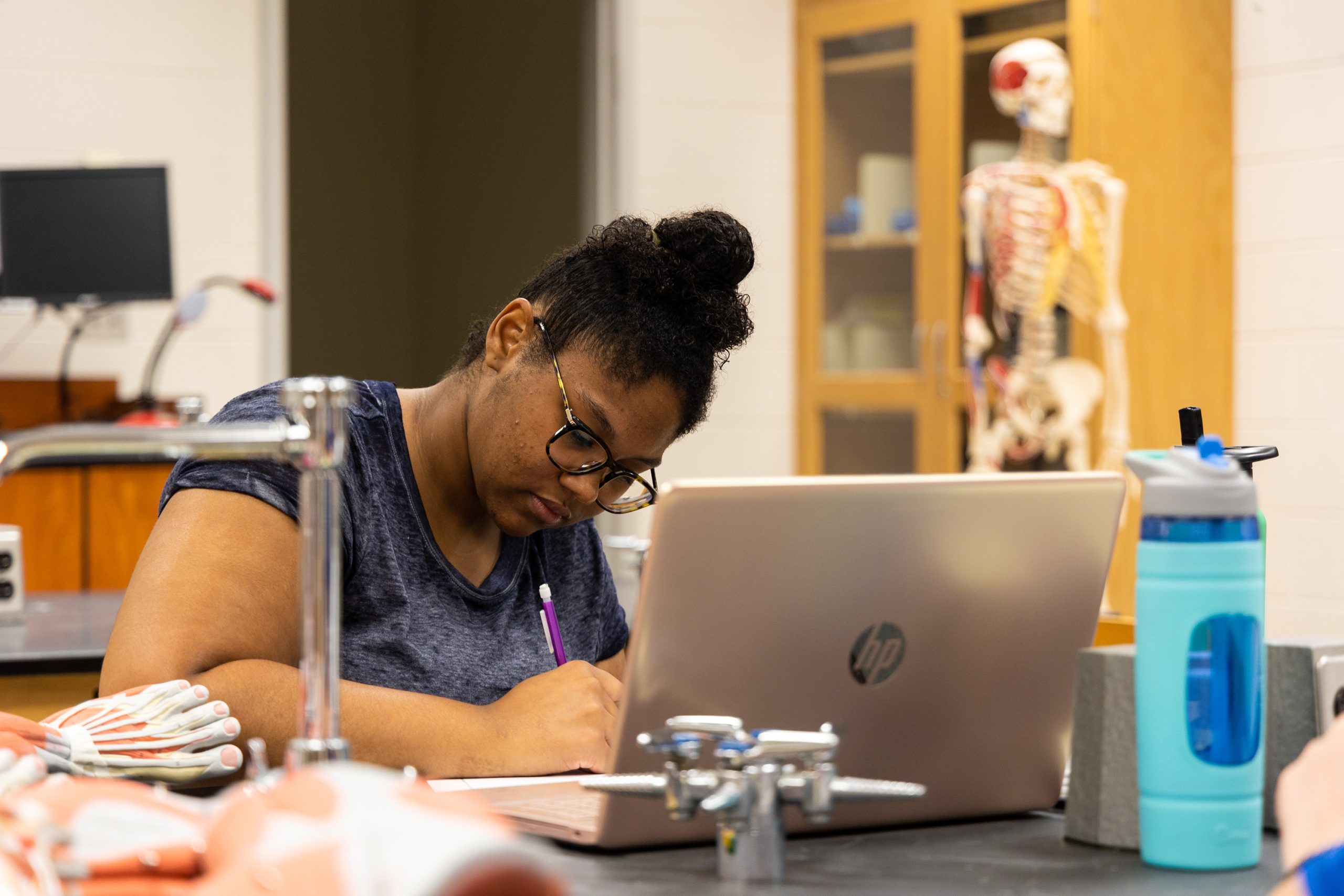 Graduate student preparing for exam in a lab