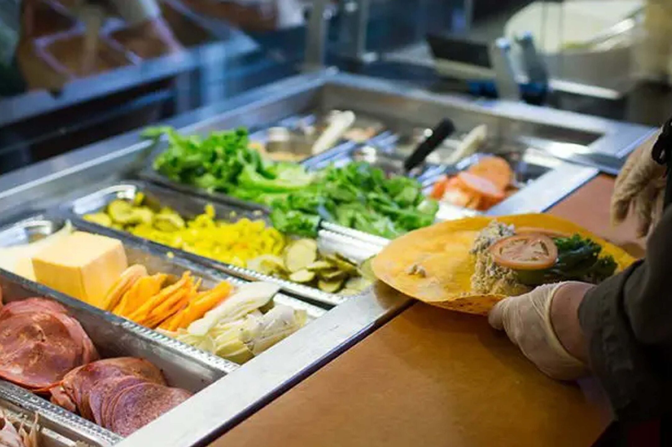 wrap station with meats, chesses, lettuce and other ingredients