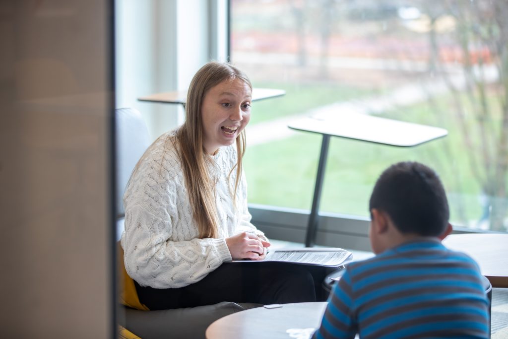 Bridgewater College TEP student teaches a second grader from a local elementary school how to use addition in word problems.